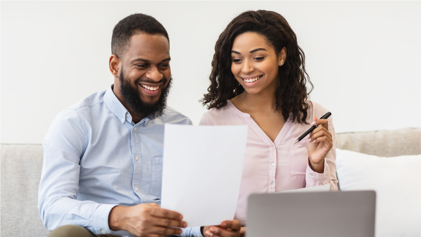 A couple is looking at a paper statement together