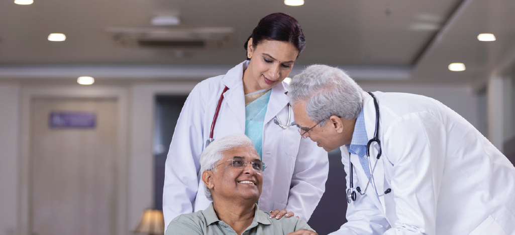 Observing Patient Bill of Rights - Doctors in a hospital speaking to a senior patient in a wheelchair.