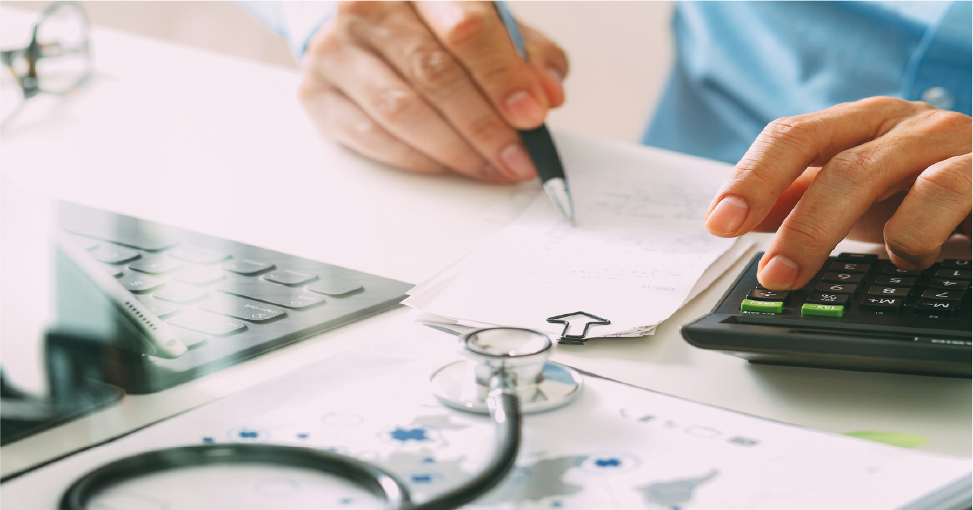 Using medical billing services vs. revenue cycle management - A doctor computing healthcare bills.