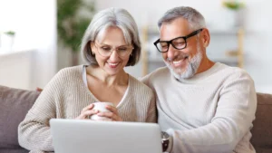 Older couple using patient engagement software to review their medical bill online together