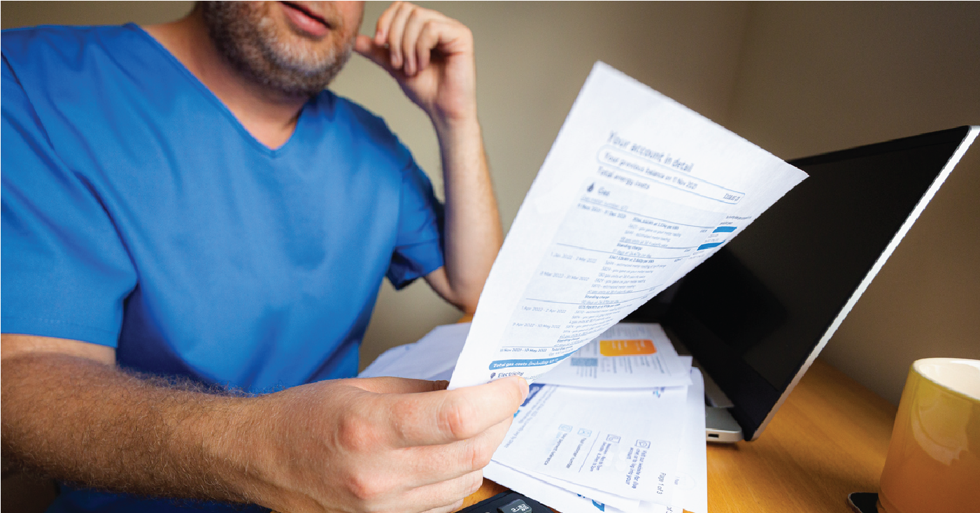 Propensity to pay concept - Man at home reviewing his medical bills.