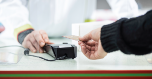 Payment processing options - A patient paying for his medical fees using a credit card.