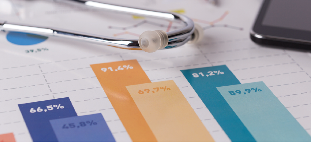 Using revenue cycle management analytics - Medical report documents showing graphs on a table with a stethoscope.