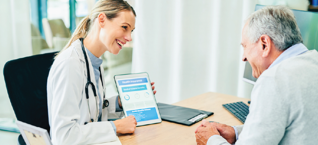 Navigating Medicare changes - Female doctor explaining health insurance to a senior man.