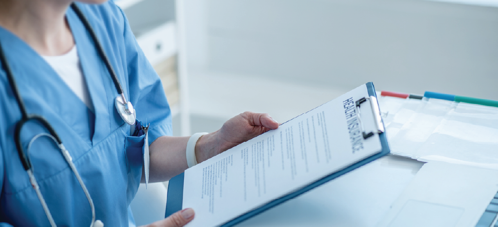 Female doctor reviewing a patient’s health insurance.
