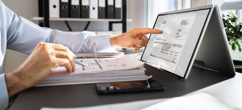 Using text and email bill notifications - A medical professional checking a patient’s bill using a tablet computer.