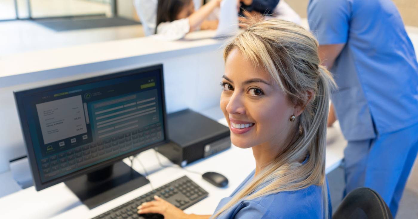 Payment Processing Ecosystem: Medical staff looks over her shoulder with a smile.