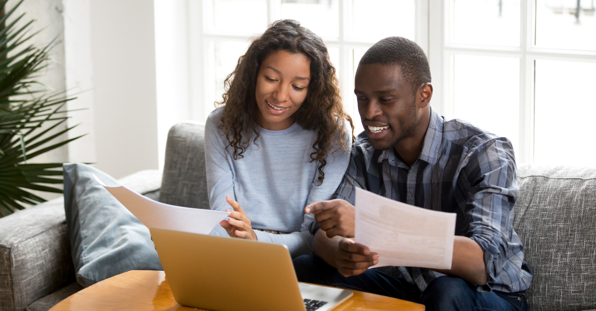 A married couple paying their bill with a mailed statement