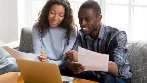 A couple looking at their paper bill