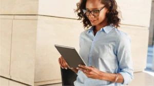 Woman looking at tablet, seeing how automation reduces administrative burden in healthcare