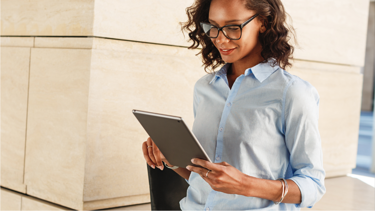 Woman looking at tablet, seeing how automation reduces administrative burden in healthcare