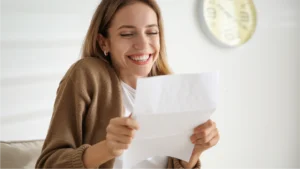 Woman opening mailed paper bills