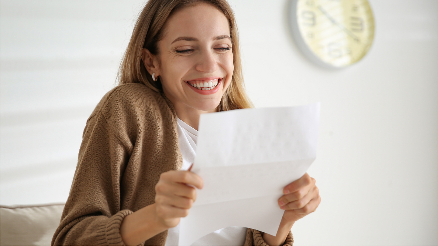 Woman opening mailed paper bills