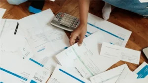 Person looking at a pile of invoices showcasing how important medical debt rules are