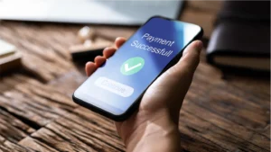 Person holding a phone that says Payment Successful