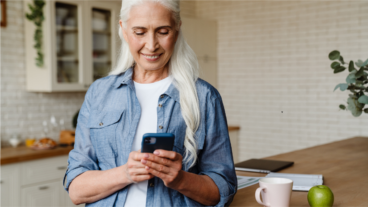 Older woman making a payment on their phone, no worried about high-deductible health plan because she can use patient financing