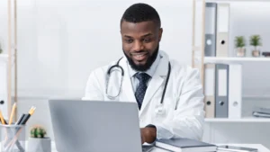 Doctor using medical practice management system on a computer in a medical office