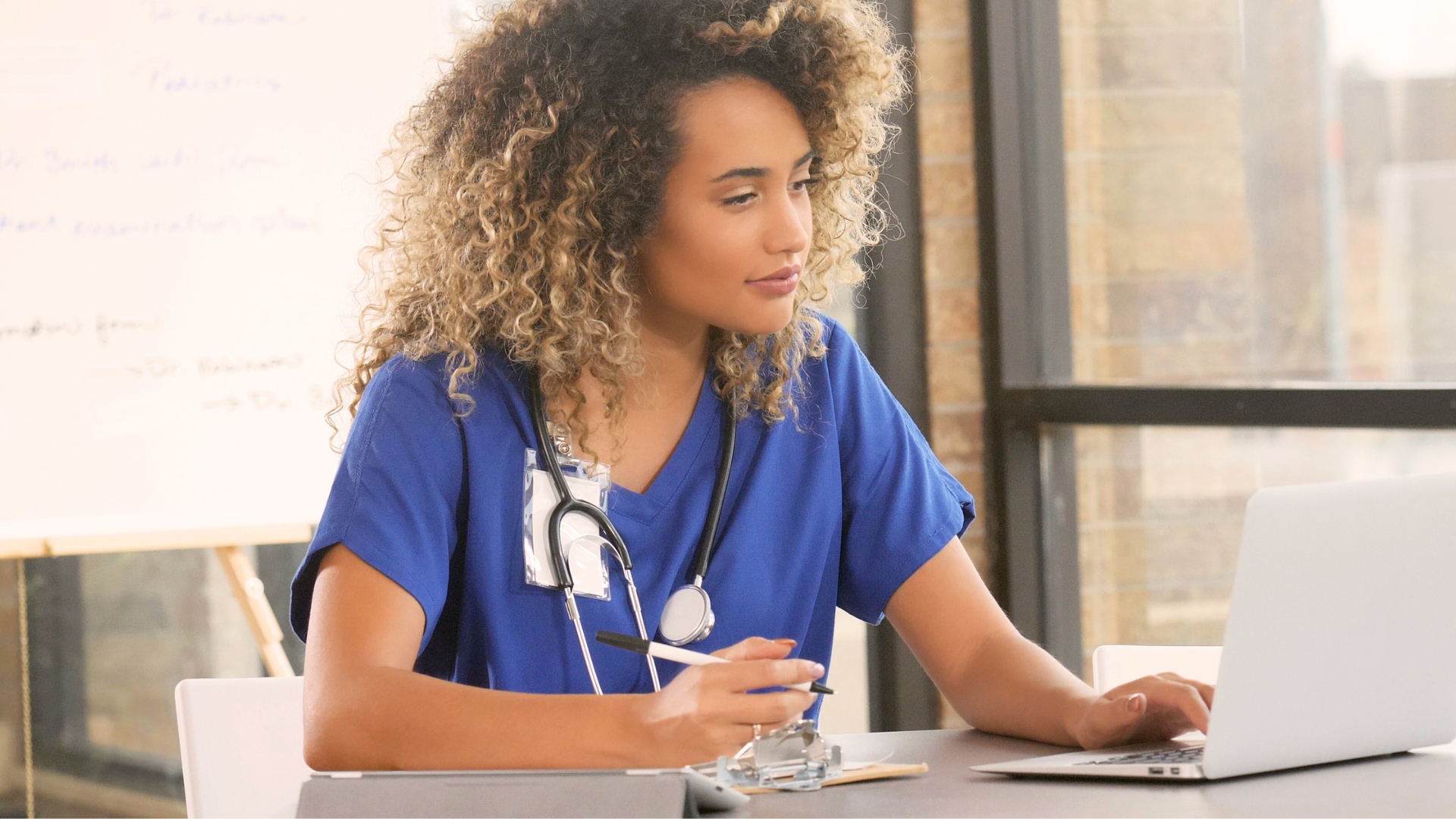 Woman using Health Information Exchange Software at a medical practice