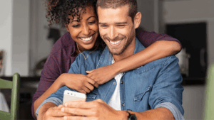 A couple looking at an automated reminder through their phone