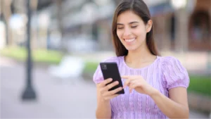 Women making a payment on her phone from a pre-collection billing text