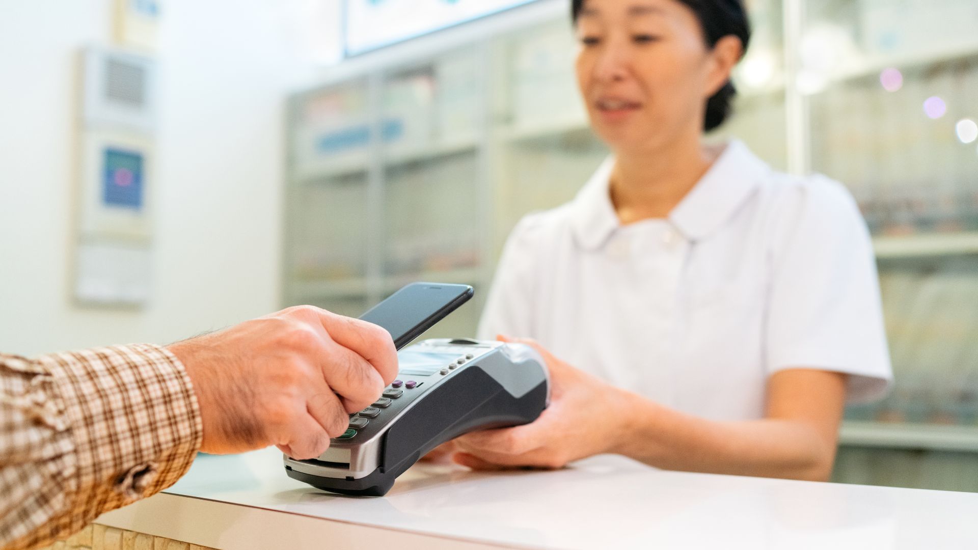 Patient making a payment with their phone at a medical office
