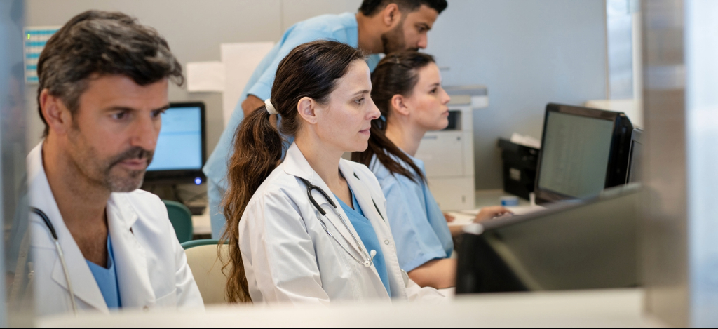 Private practice billing - A group of medical professionals using computers to manage administrative tasks.