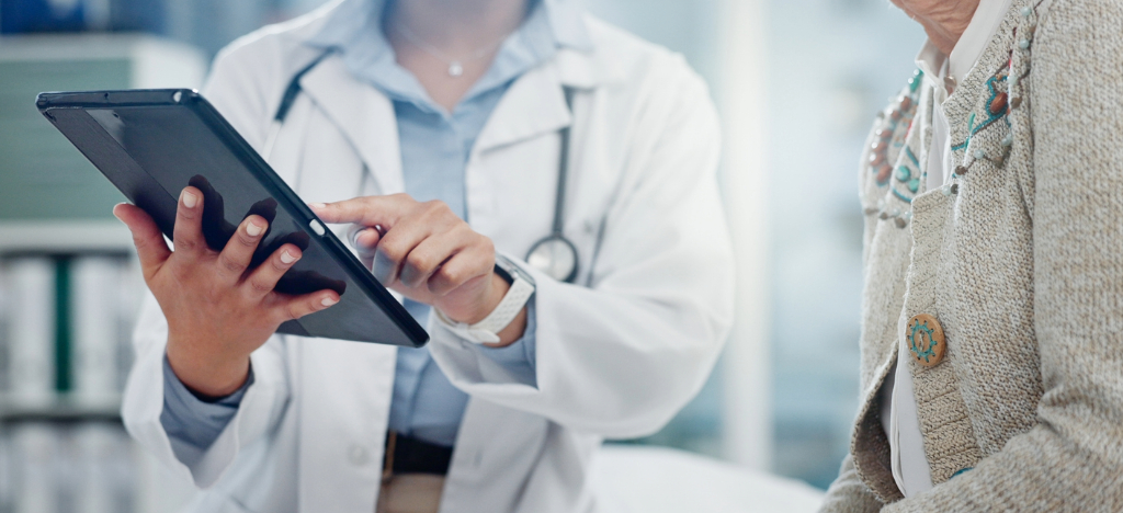 Improving your billing workflow process - A female doctor explaining billing options to her senior patient.