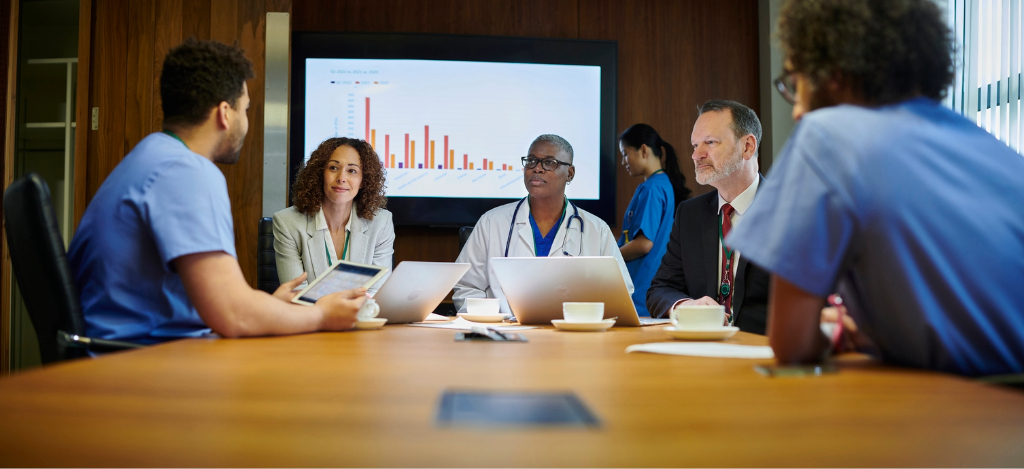 Addressing the deductible reset - A team of medical and business professionals discussing their practice’s revenue.