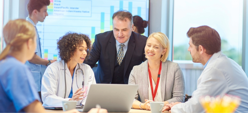 Revenue cycle management companies - A group of healthcare professionals and business partners discussing their practice’s RCM.