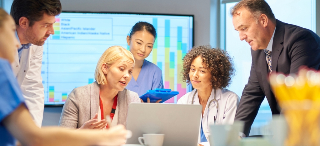 Revenue cycle partner - A group of medical experts reviewing their practice’s revenue with their business partners.