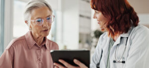 Medical office payments - A female doctor explaining medical charges to her senior female patient.