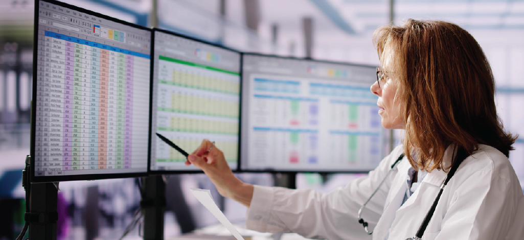 Patient financing options for better revenue - A female doctor checking hospital revenue shown on a computer screen.