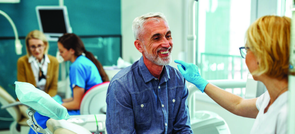 Patients who can’t afford dental care - A female dentist explaining dental procedures to her male senior patient.