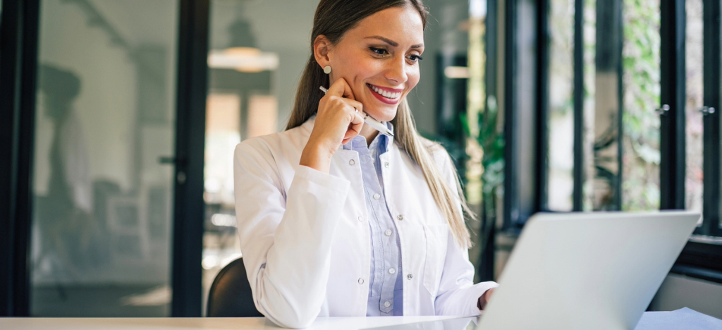Plastic surgery clinics - A female doctor using a laptop to review her clinic’s revenue status.