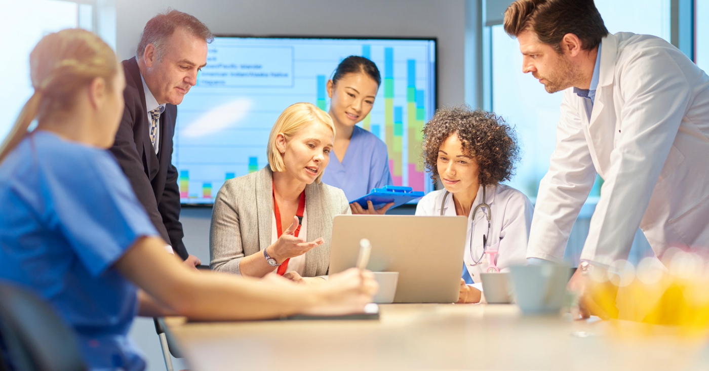 Get paid faster - A team of business owners and medical professionals discussing solutions to increase their practice’s revenue.