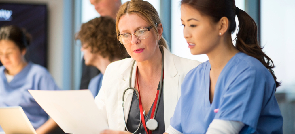 Outsourcing medical billing - A team of medical professionals reviewing their practice’s key metrics.