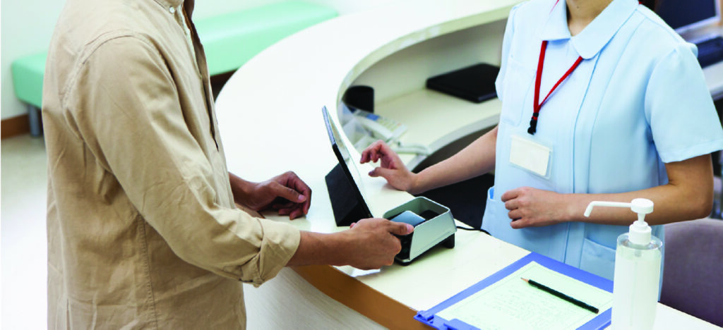 A man paying at a hospital using a smartphone.