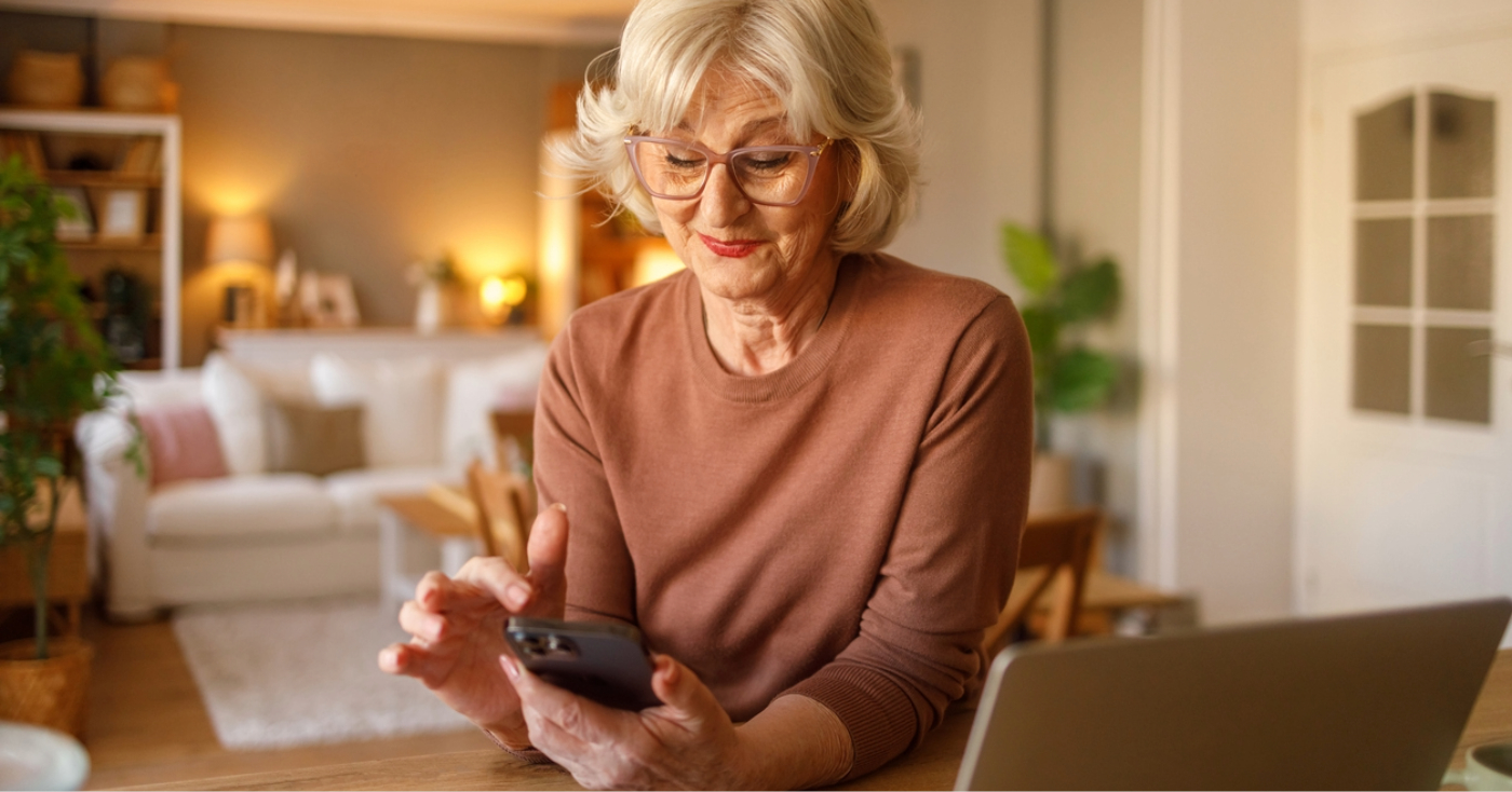 Patient messaging - A senior woman at home using her smartphone to communicate with her healthcare provider.