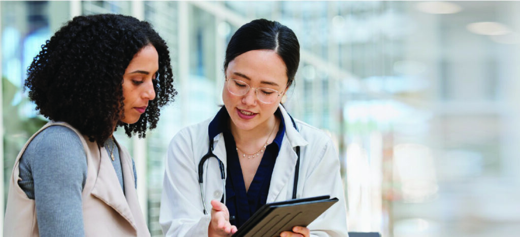 Improving patient communication and satisfaction - A female doctor explaining medical billing options to her female patient.