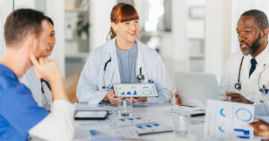 Rev cycle management - A group of doctors having a meeting about their practice’s revenue.