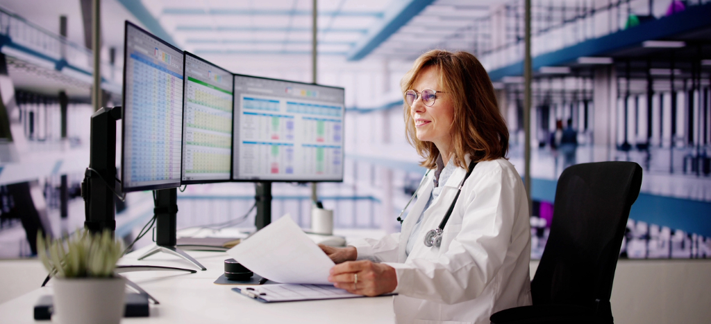 A female doctor using a computer to check for her practice’s revenue.