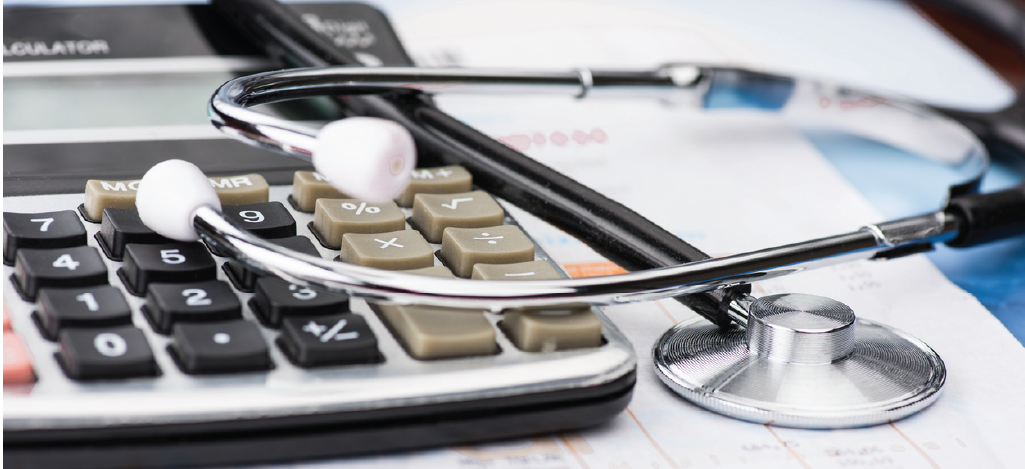 Benefits of patient financing - Financial documents with a doctor’s stethoscope and calculator on a table.
