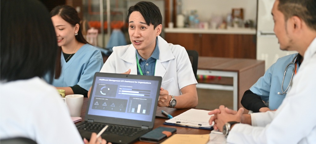 Smart billing solutions for healthcare practices - A group of medical professionals discussing their practice’s revenue during a meeting.