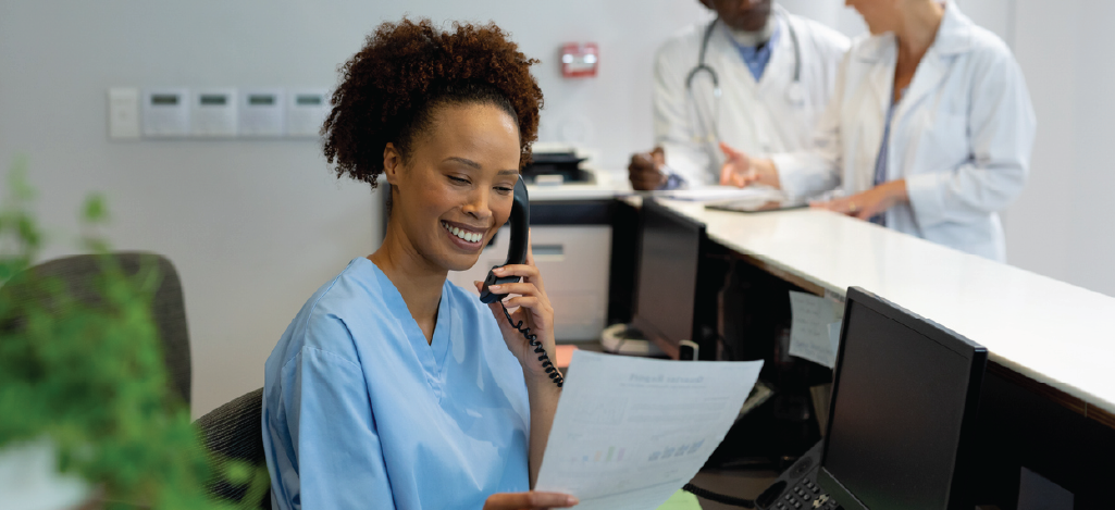 Implementing medical billing for small practices - A female medical staff on the phone with a billing services provider.