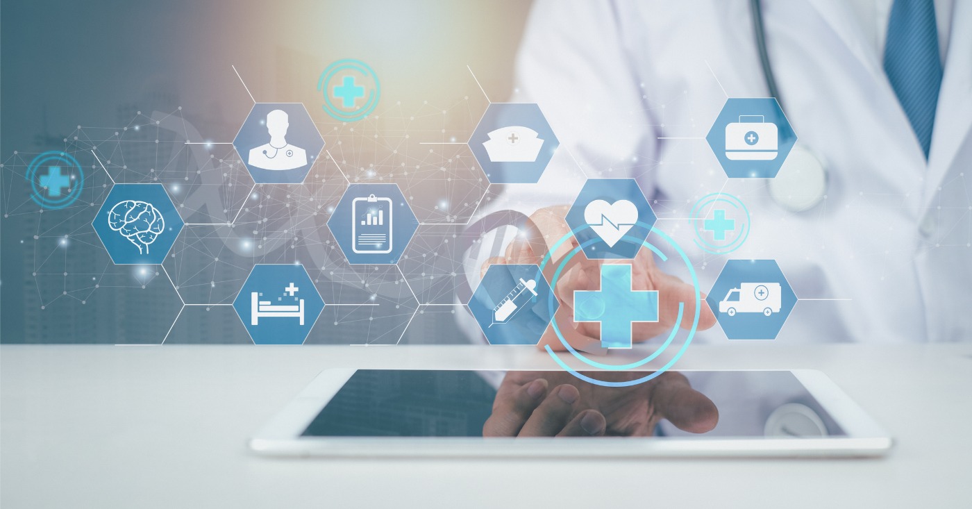 Automation in healthcare - A doctor using a tablet device showing digital medical technology icons.