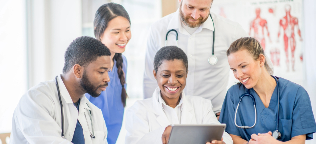 RCM medical billing - A group of medical professionals checking their practice’s medical software through a tablet device.
