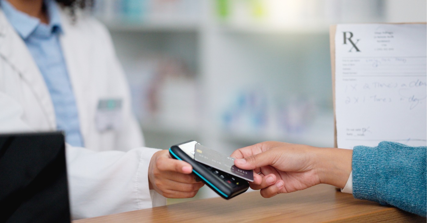 Mastering payment collections - A patient scanning her credit card to pay for her medical bills.