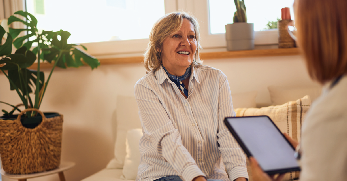 Mental health billing software must-haves - A female mental health professional discussing financing options with her female patient.