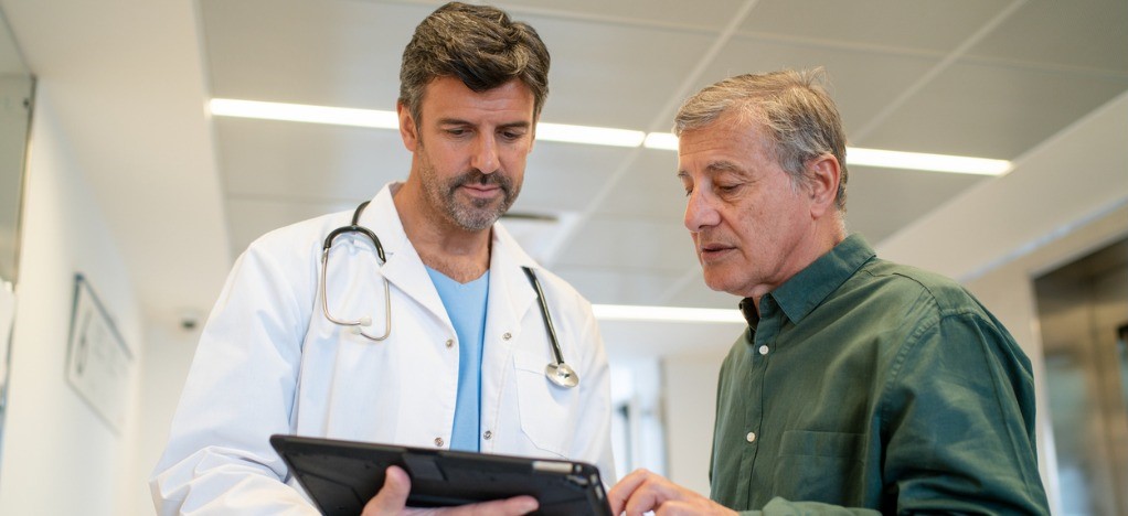 Accounts receivable in medical billing - A male doctor offering flexible payment options to his senior male patient.