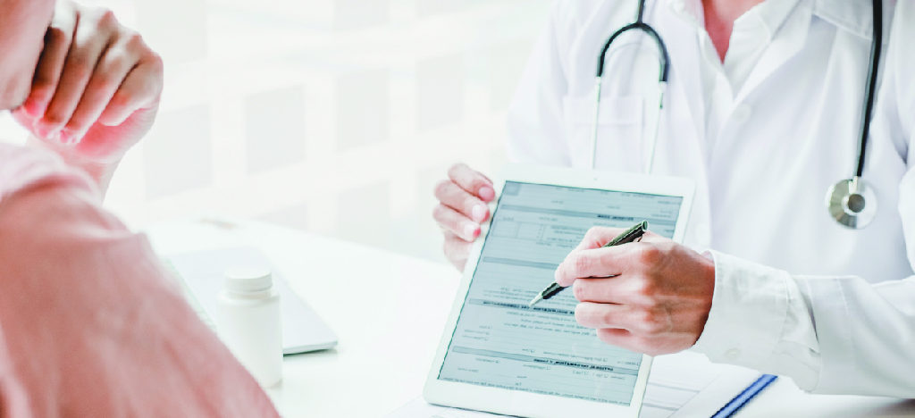 Patient statement service - A doctor using a tablet device to explain payment options to his patient.